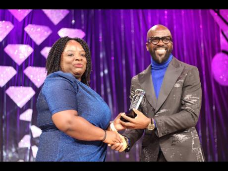 Petra-Kaye Linton receives her Sterling Gospel Music Award for Female Artiste of the Year from Ian ‘Ity’ Ellis. 