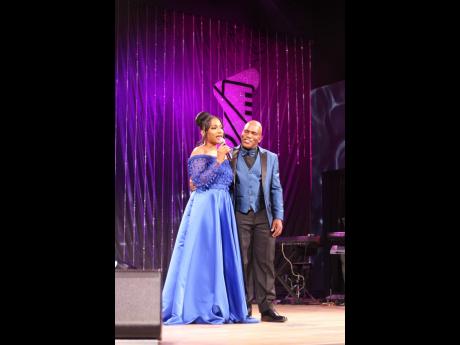 Basil Barnaby runs to the side of his daughter, founder of the Sterling Gospel Music Awards Basillia Barnaby-Cuff, as she breaks down during her opening speech for the event, held at The Ambassadors last Saturday. 