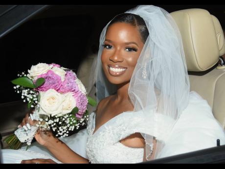 The stunning bride sits pretty, bouquet in hand.