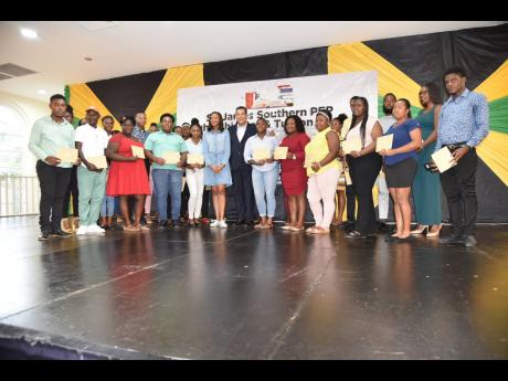 Homer Davis (centre right), member of parliament (MP) for Southern St James, and  Rhoda Moy Crawford (centre left),  MP, Manchester Central, who was the guest speaker, stand with the 2022 beneficiaries of the Southern St James Tertiary Education Scholarshi