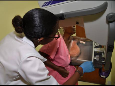 A client being assisted with her mammograph screening.