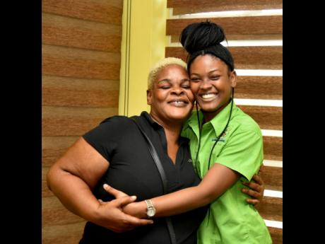 Celine Sitladeen and her mother, Faithlyn Style, celebrate after the 20-year-old was awarded a scholarship to attend the College of Agriculture, Science and Education (CASE).