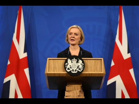 Britain's Prime Minister Liz Truss attends a press conference in the Downing Street Briefing Room in central London, Friday October 14, 2022, following the sacking of the finance minister in response to a budget that sparked markets chaos.