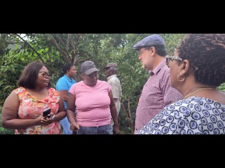 People’s National Party President Mark Golding in dialougue with residents of Pleasant Hill, St Catherine, on Friday. The residents are on edge after being served with eviction notices last week.
