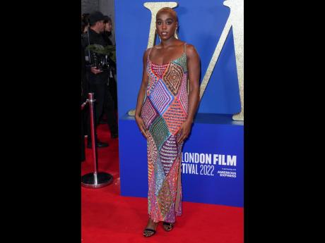 Lashana Lynch poses for photographers upon arrival for the première of the film ‘Roald Dahl’s Matilda The Musical’ on the opening evening of the 2022 London Film Festival wearing the Morocco sequin gown by Ashish and Christian Louboutin.