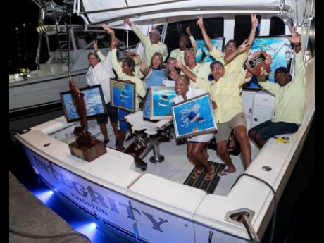 ‘Integrity’ yacht crew led by Lillan Limited’s Andrea and Peter Cowan (front right)  celebrating their win  at the 59th annual International Marlin Tournament at the Old Marina, Portland.