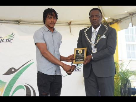 Horatio Campbell (left) receives his Mayor’s Special Award for Gallantry from Montego Bay Mayor Leeroy Williams during the Heroes’ Day Civic and Awards Ceremony in Sam Sharpe Square on Monday.