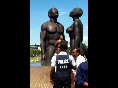 Ian Allen’s award-winning photo ’Third Statue’, of a nude woman standing by the controversial ’Redemption Song’ statue at Emancipation Park, New Kingston.