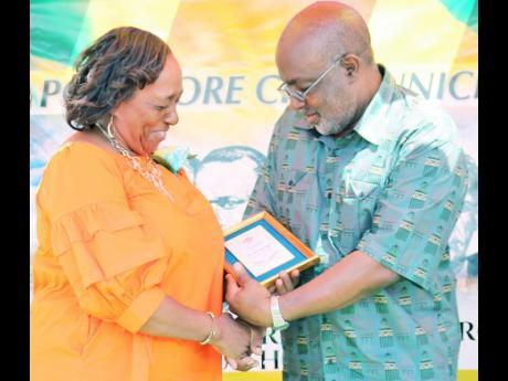 Member of Parliament for St Catherine Southern, Fitz Jackson, had president of the Kiwanis Club of Greater Portmore, Cecile Robinson-Bodden, in stitches as she accepted an award on behalf of the club.