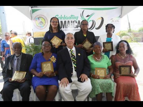 William Shagoury (seated, centre), custos of Clarendon, celebrates with the awardees for education (seated from left) Clinton Wilson, Imogene Stephenson, Hyacinth Grose and Enid Sinclair. Standing (from left), Christine Munroe-Walters, Pearlyn Clark and Be