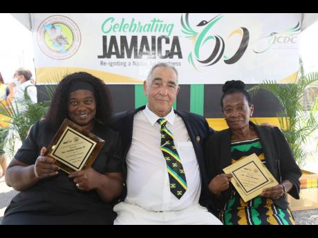 William Shagoury, custos of Clarendon, celebrates with the awardees for agriculture & fisheries, Pauline Givans (left) and Mary Williams.