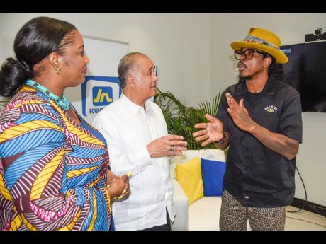 Host Dahlia Harris and Parris Lyew-Ayee Sr, chairman of the JN Foundation, listen to veteran photographer Radcliffe ‘Ruddy’ Roye who was the guest of Tuesday’s Fireside Chat at JN’s corporate office at Oxford Road, New Kingston.