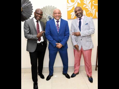 Mark Chisholm, chief revenue officer of insurance at Sagicor, is flanked by Leighton Morgan (left), agency manager, and Sean Edwards, director of sales. 