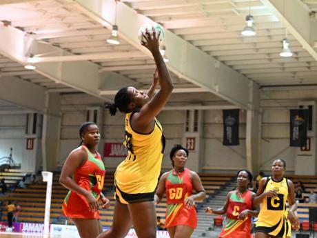 Sunshine Girls captain Jhaniele Fowler makes a grab during her team’s Americas Netball World Cup qualifiers game against Grenada at the National Indoor Sports Centre yesterday.