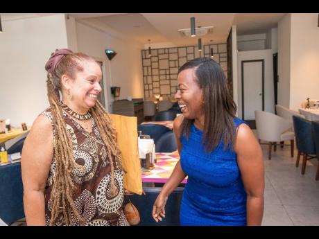 Dr Kerida McDonald (left), shares a laugh with Sutania Williams, supervising producer, RJRGLEANER Group. 