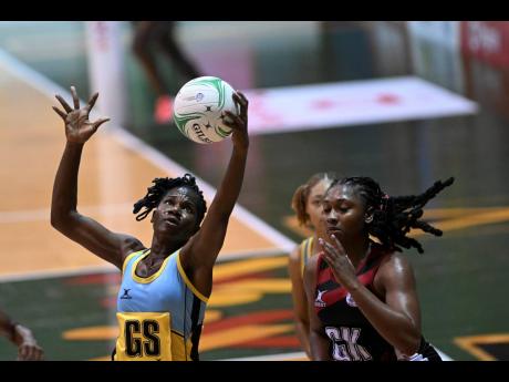  St Lucia’s Shem Maxwell (left) catches the ball ahead of Trinidad and Tobago’s Shaquanda Greene-Noel during their Americas Netball World Cup qualifier at the National Indoor Sports Centre on Sunday, October 16.
