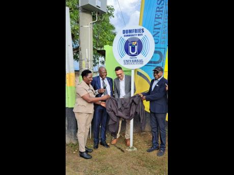 Edmund Bartlett (right), member of Parliament for St James East Central, participates in unveiling the new community Wi-Fi hotspot in Dumfries, St James on Thursday, October 20. Also pictured, from left: Angela McIntosh-Gayle, deputy superintendent of Poli