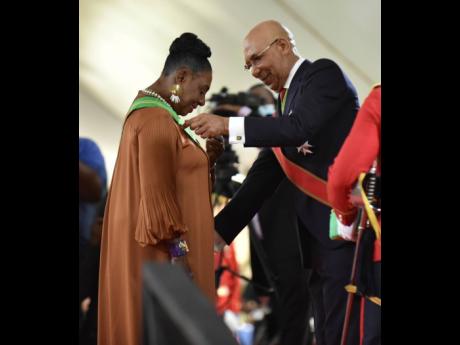 
Governor General Sir Patrick Allen (right),  invests Minister of Culture, Gender, Entertainment and Sport Olivia Grange, into the Order of Jamaica. 
