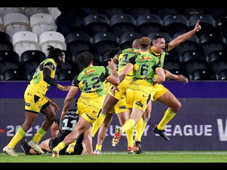 
Jamaica’s Ben Jones-Bishop (right) celebrates with teammates after scoring their side’s first try during the Rugby League World Cup group C match between New Zealand and Jamaica at the MKM Stadium, Kingston upon Hull, England, yesterday.
