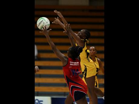 Jamaica’s Crystal Plummer (right) moves to block a pass to Cayman Islands’ Deidrian Gardner during an Americas Netball World Cup qualifier at the National Indoor Sports Centre on Tuesday, October 18.