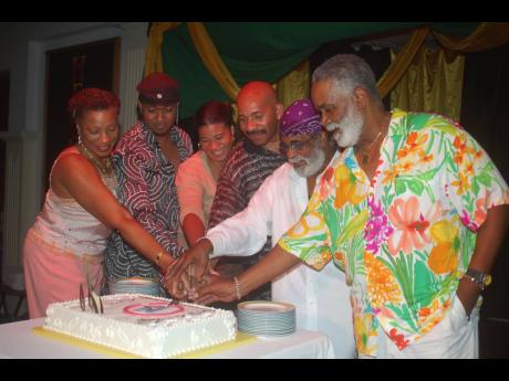 From left, Sally Schloss, Craig Ross, Devine Blake, Michael ‘Silky’ Schloss, Winston Blake, Monte Blake of  Merritone Music cutting their sweet sixteen family reunion cake at Hedonism III over Heroes weekend at their annual family reunion and jerk fest