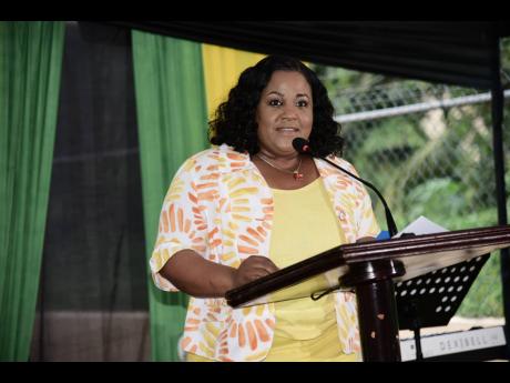 Natalie Neita-Garvey, opposition spokesperson on local government and sports, delivers an address during the renaming ceremony for Glover Allen Drive in Granville, St James, last Thursday.