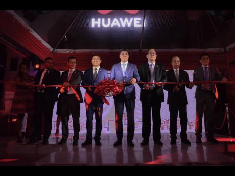 Prime Minister Andrew Holness (centre), engages in a symbolic ribbon cutting with (from left) Huawei Jamaica CEO of Carrier Network BG, Neil Grant; Huawei Vice-President to Latin America Micheal Xue Feng; Chen Daojiang, ambassador of the People’s Republi