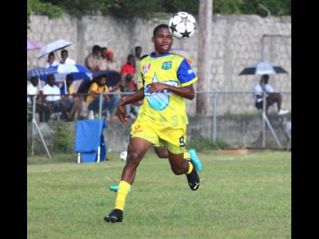 Clarendon College’s Carlos Cooper, who scored the second goal against St Mary Technical High School, watches the ball closely during their ISSA daCosta Cup encounter at Foga Road yesterday.