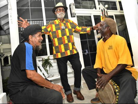 Monte Blake (centre) danced to the dumming of Calvin Mitchell (left) and Phillip Supersad.