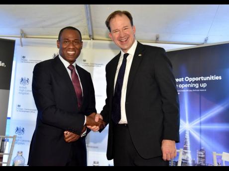 Minister of Finance Dr Nigel Clarke (left) greets United Kingdom Minister for the Americas and Overseas Territories Jesse Norman during the launch of the British International Investment at the British High Commission on Tuesday.