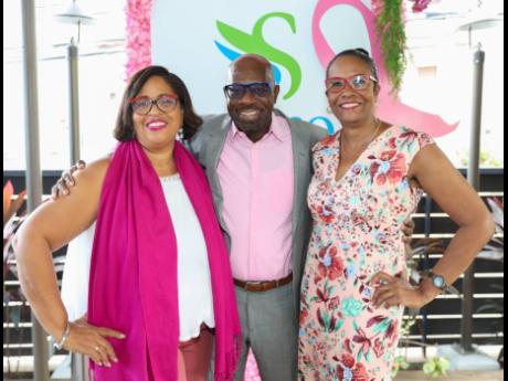 Breast cancer survivors and Sagicor Group Jamaica team members Frances Angus (left) and Michelle Distant join Karl Williams, executive vice-president, shared services, Sagicor, for a quick photo op before lunch.
