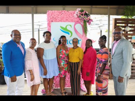 Karl Williams (right), executive vice-president, shared services, Sagicor Group Jamaica, and Michael Leslie, acting executive director of the Jamaica Cancer Society (left), stand with the six breast cancer survivors who are a part of Sagicor’s Together W