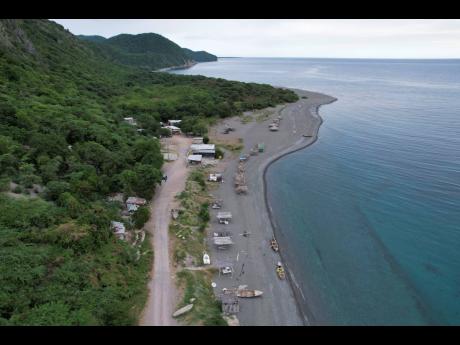 The Caribbean Sea hugs the shoreline along Bob Marley Beach in Bull Bay, St Thomas, on Thursday. Woof Group director Donovan Reid said the pending US$200m hotel investment slated for the area, where informal settlers live, will transform the tourism sector