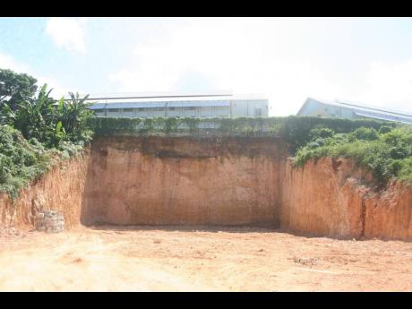 A view of the precipitous drop next to the agricultural plot of the Hopewell High School in Hanover. The land was excavated as part of preparation activities for construction at the neighbouring property owned by the Doer of Faith Church of God.  
