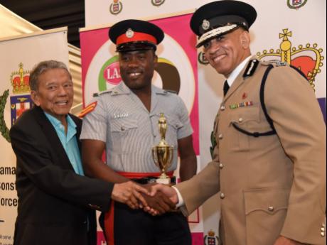 Corporal Rohan Smith (centre) with Lascelles Chin (left), founder and executive chairman of LASCO Affiliated Companies and Major Antony Anderson, commissioner of police, shortly after winning the LASCO/Jamaica Constabulary Force (JCF) Police Officer of the