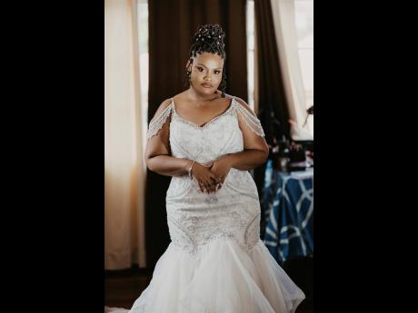 The bride walked up the aisle in this stunning mermaid-cut wedding dress from Bliss Bridal Boutique, which lovingly hugged her curves.