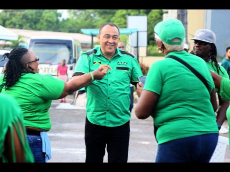 Dr Christopher Tufton, minister of health and wellness, is greeted by Jamaica Labour Party supporters on his arrival at the Clarendon Central constituency conference at Denbigh High School on Sunday. Tufton is scheduled to make a statement to lawmakers in 