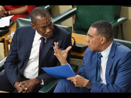 Prime Minister Andrew Holness (right) makes a point to Dr Nigel Clarke, the minister of finance and public service, during Tuesday’s sitting of the House of Representatives on Tuesday.