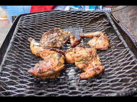 Chef Gentles’ jerk chicken was hot and ready for those who strolled the streets of Water Lane for Kingston Creative Artwalk on Sunday. 
