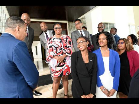 Prime Minister Andrew Holness (left) greets the Jamaica House Fellows as Dr Wayne Henry (second left), director general of the Planning Institute of Jamaica, and Wayne Robertson (third left), permanent secretary (acting) in the Ministry of Legal and Consti