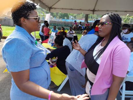 Kenisha Coke -Woolery (left), social worker  in the Ministry of Labour and Social Security, and Tracy Ann Pinnock, manager of the Sam Sharpe Teachers’ College Diagnostic and Early Intervention Centre, discuss the needs of adults and children who attended