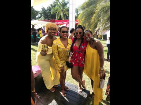 Randia Coakley (left) catches up with some friends in Jamaica at the popular Sunrise Breakfast Party. 