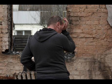 
Vadym Zherdetsky reacts standing in the remains of his destroyed house in the village of Moshun, outside Kyiv, Ukraine, on Friday, November 4.
