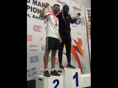 Jamaica’s Akino Lindsay (right) with England’s Joe Pitman, who he defeated in heavyweight points sparring to complete a double-gold performance at the International Sports Kickboxing Association’s Amateur Members Association World Championships at th