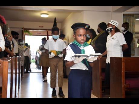 Chloe Bailey of the Adventure Club leads uniformed colleagues during the flag-posting ceremonial procession at Andrews Memorial Seventh-day Adventist Church on Saturday. 