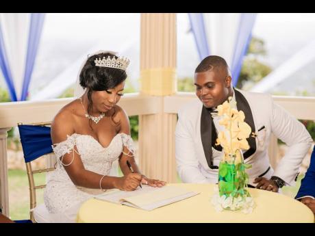 Abigail signs the marriage certificate to officially become Mrs Witter, while her husband, Chevaughn, looks on in approval. 