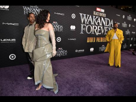 From left: ASAP Rocky, Rihanna and Michael B Jordan walk the purple carpet.