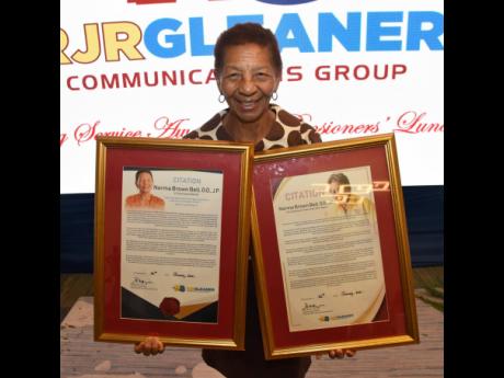 Norma Brown-Bell poses with her citations for long and meritorious service during the RJRGLEANER Long-Service Awards and Pensioners’ Luncheon at the AC Hotel in Kingston on Tuesday.