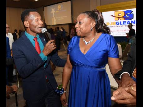 Sylyn Brown-Hamilton, purchasing officer at The Gleaner Company (Media) Limited, is serenaded by Peter Carter from the I-5 Band during the RJRGLEANER Long-Service Awards and Pensioners’ Luncheon at the AC Hotel in Kingston on Tuesday.