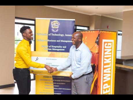 University of Technology Jamaica’s Food and Beverage Programme Director Richard Warren (right) congratulates Shaquille Blair on his victory.